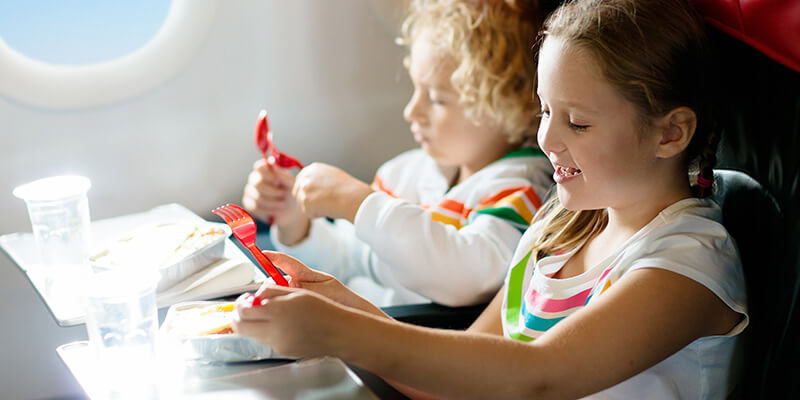 children eating on plane