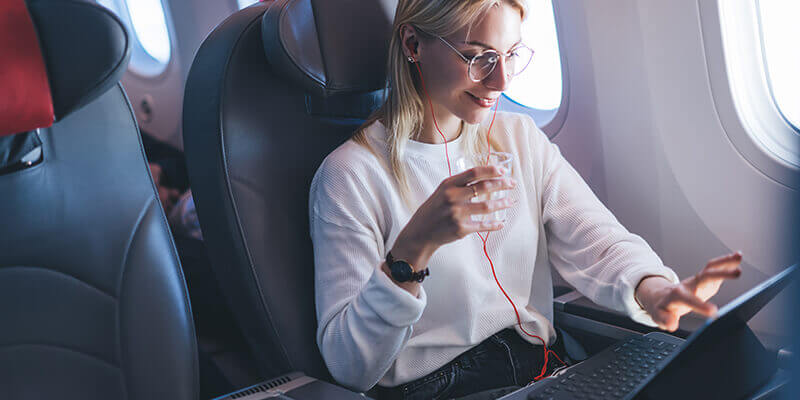 Girl listening to music on flight