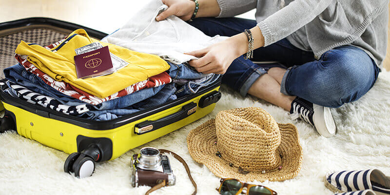 Woman packing suitcase